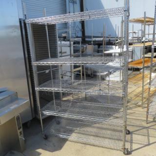 Metro shelving unit on casters, 5 wire shelves, 48x18x76 inches, sturdy metal construction, good condition.