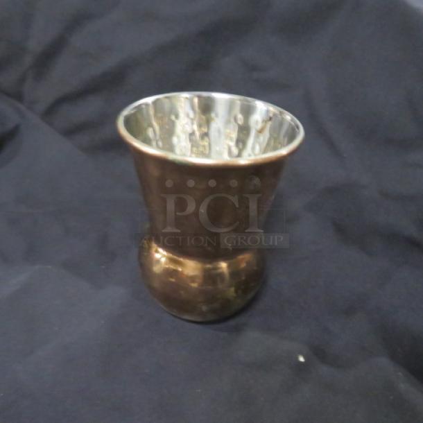 Copper-finished Moscow Mule mug with a hammered texture, shiny interior, and bulbous base, in good condition.