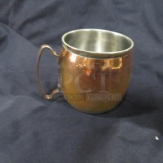 Copper Moscow Mule mug with a stainless steel interior, featuring a smooth rounded body and a sturdy handle.