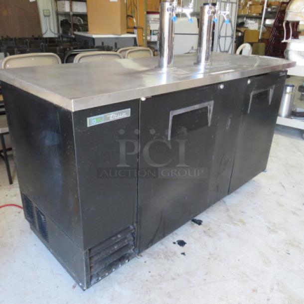 True TDD-3-HC keg box with 2 towers, 4 taps, drain; 69x28x35.5 inches. Right door needs repair.