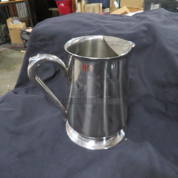 New Vollrath stainless steel water pitcher, model 46154. Features a sleek design and sturdy handle. Mint condition.