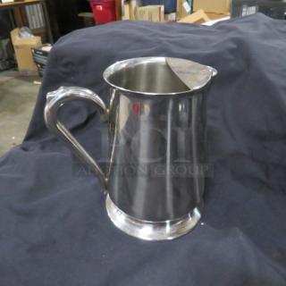 New Vollrath stainless steel water pitcher, model 46154. Features a sleek design and sturdy handle. Mint condition.