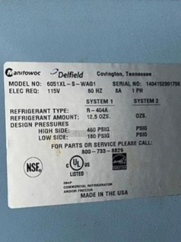 Label on Delfield 6051XL-S-WAQ1 refrigerator. Model, refrigerant info, and service contact details visible. Made in USA.