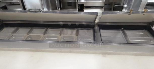 True TPP-67 pizza prep table refrigerator, 67" two-door model in outstanding condition. Includes multiple food pans, stainless steel construction, tested and working at 115V.