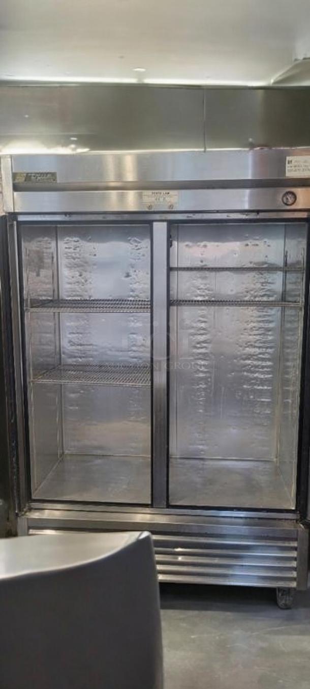 Immaculate True T-49 two-door reach-in refrigerator, 115V, stainless steel, shelves included, fully tested, working condition.