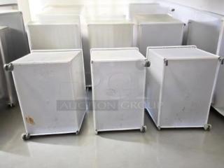 Set of three white ingredient storage bins on casters, with scoops and clear sliding lids. Fully tested, commercial grade.