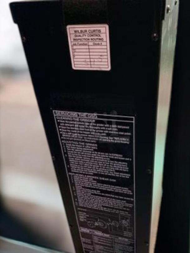Wilbur Curtis GSG-3BLK coffee grinder, excellent condition, black, 120V, quality control label, operational instructions visible.