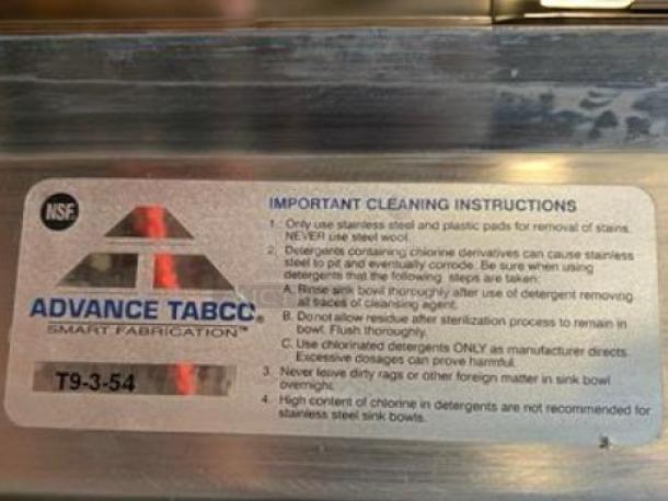 Brand new Advance Tabco T9-3-54 stainless steel 3-compartment sink with backsplash; NSF certified, cleaning instructions label visible.