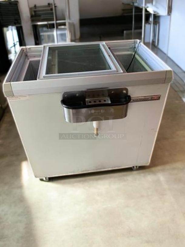 Commercial sliding glass top chest freezer in outstanding condition, features a 115V power setup, fully tested and working.