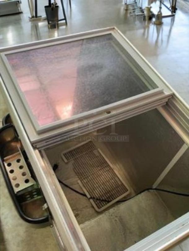 Commercial sliding glass top ice cream/beverage freezer, 115V, fully tested, outstanding condition, ideal for retail use.