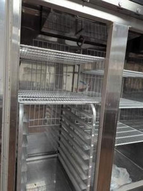 Randell R4S-6 54" double door reach-in refrigerator, top-tier condition, visible shelving, stainless steel interior.