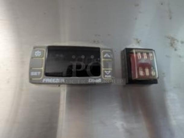 Digital temperature control panel and electrical connector for Icecasa TSS-54F-HC freezer, stainless steel background.