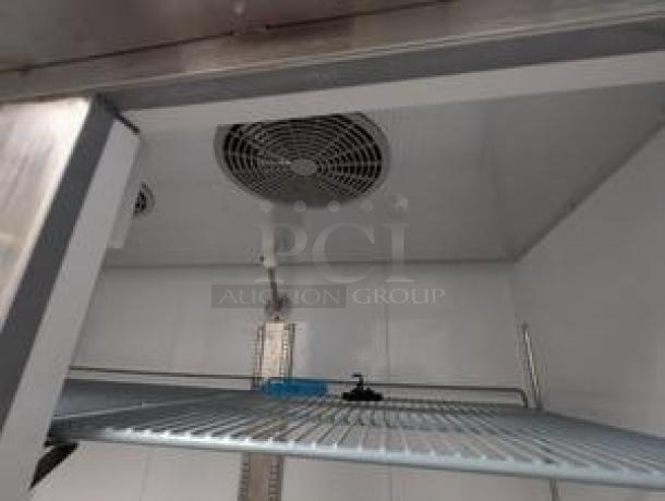 Icecasa TSS-54F-HC 54" double door reach-in freezer interior, pristine condition, shelf and fan visible, 115V.