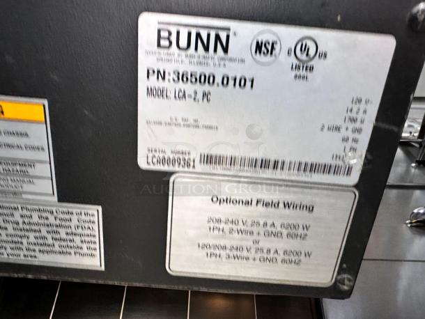 Alt text: Close-up of Bunn LCA-2 PC dual flavor hot coffee/tea concentrate dispenser label, showing model, serial number, and wiring info.