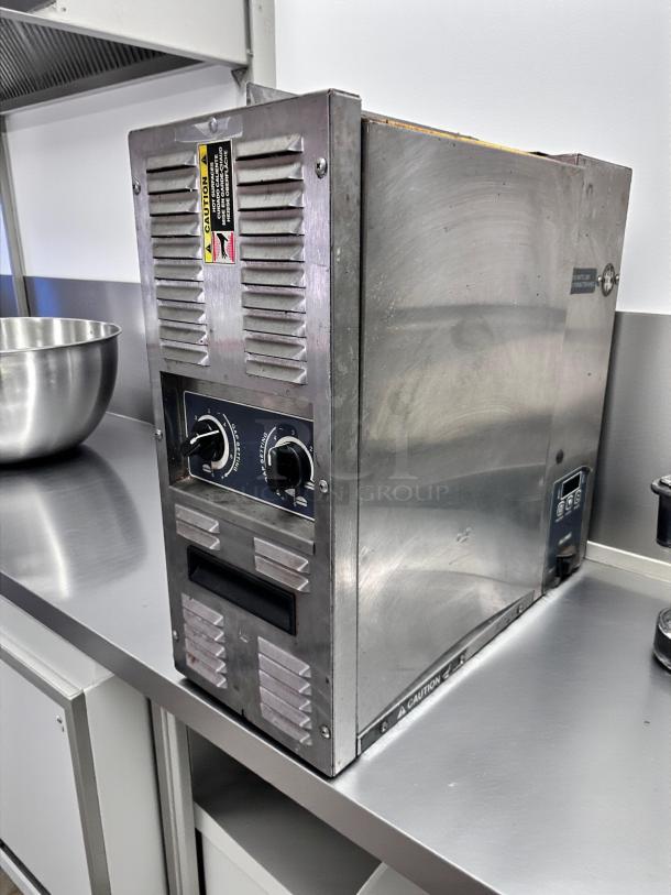 Superior condition Roundup commercial conveyor toaster with butter wheel, 208V, fully tested, stainless steel, model label visible.