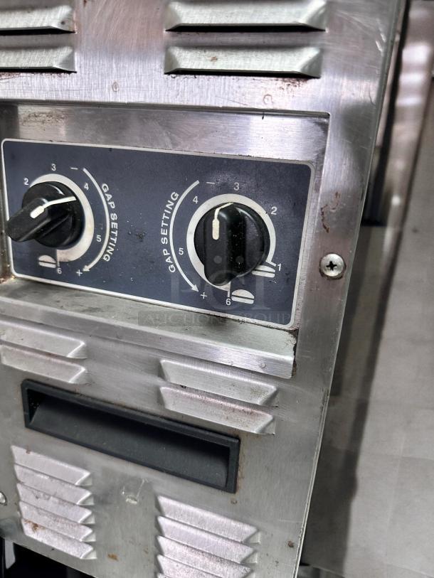 Roundup conveyor toaster with butter wheel, stainless steel, gap setting knobs visible, excellent condition, 208V, fully tested.