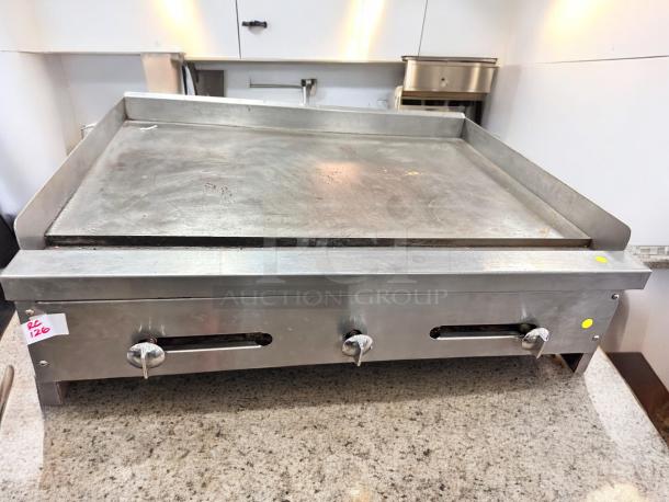 Commercial stainless steel flat top gas griddle, 36-inch, superb condition, fully tested, features sturdy knobs and vent slots.