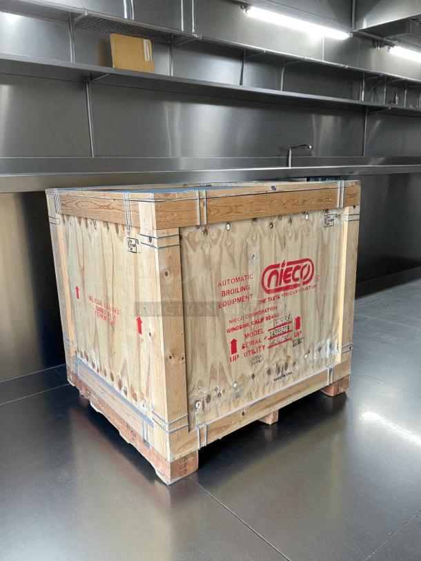 New Nieco JF93E Electric Broilvection broiler in crate; ventless, 208 volts, 3-phase. Markings indicate model and utility details.
