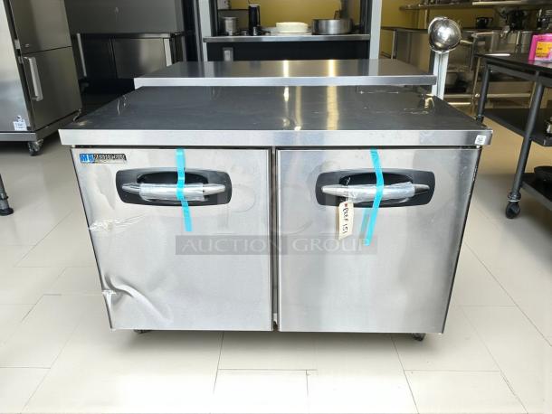 New Master-Bilt MBUR48 reach-in undercounter refrigerator. Stainless steel, tested, with minor dent. Labeled "MBUR48", new condition.