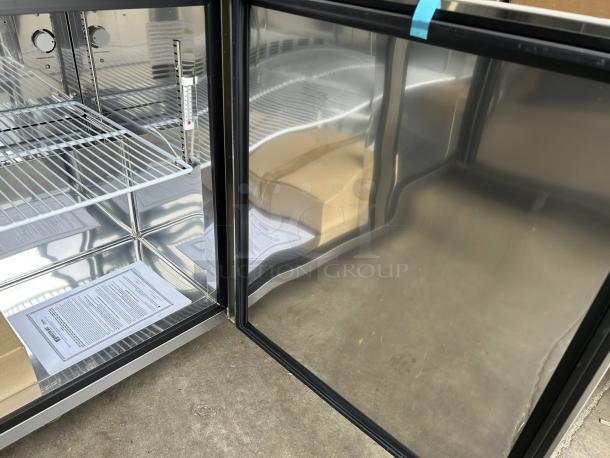 New Master-Bilt MBUR48 undercounter refrigerator, stainless steel, tested, working. Features adjustable shelves, instruction manual visible.