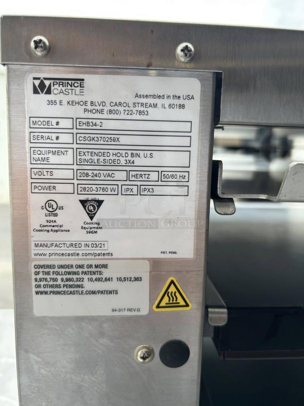Prince Castle EHB34-2 electric heated holding bin, 33-inch countertop, dual-side pass-through, great condition, model tag visible.