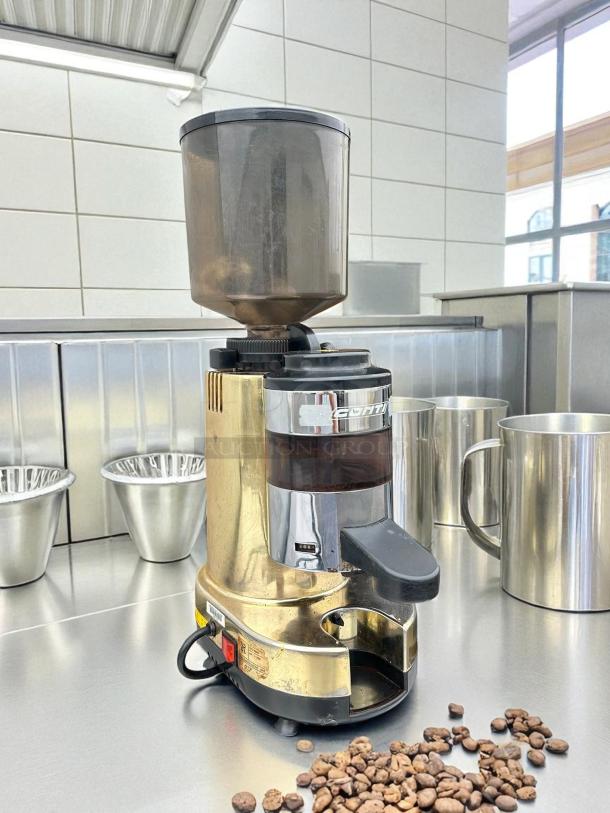 Gino Rossi RR45 commercial coffee grinder in tested, working condition. Features a gold finish and visible model label.