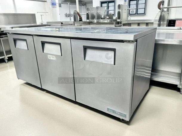 True TUC-72-HC undercounter refrigerator, 72" W, three sections and doors, stainless steel, excellent condition, tested and working.