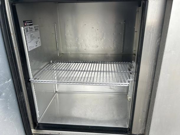 True TUC-72-HC undercounter refrigerator interior view, showing shelves and label; excellent condition, 72-inch width.