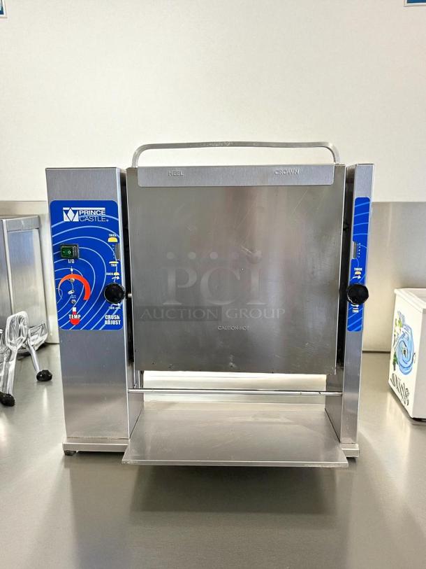 Prince Castle 297-T20 Slim-Line Vertical Contact Toaster in excellent condition, 1200 buns/hour capacity, 115V, 1500W, with control dials and caution markings visible.