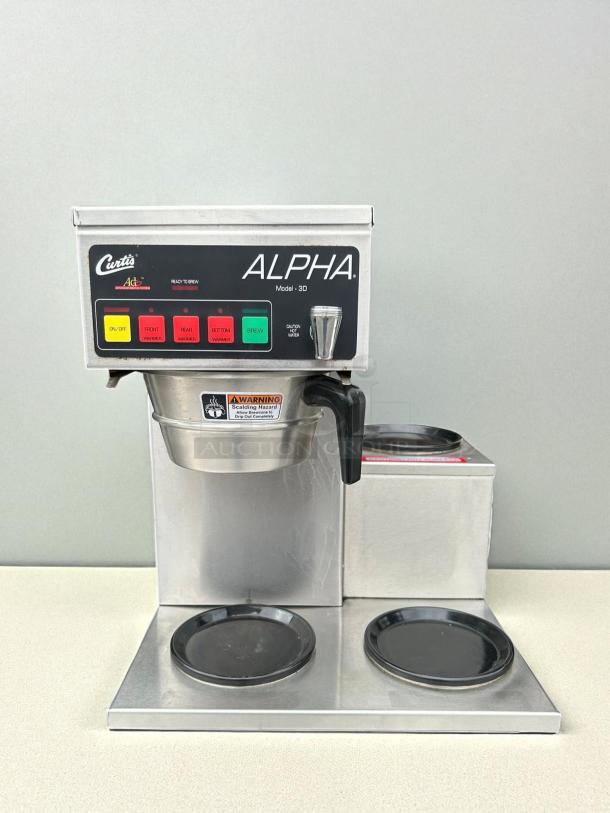 Curtis Alpha 3DR coffee brewer with three lower right warmers, 120/220V, in great condition, tested and working.