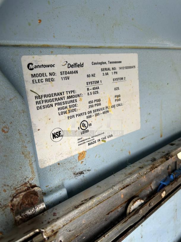 Label on a Delfield STD4464NP refrigerated prep table, showing model, serial number, and refrigerant details.