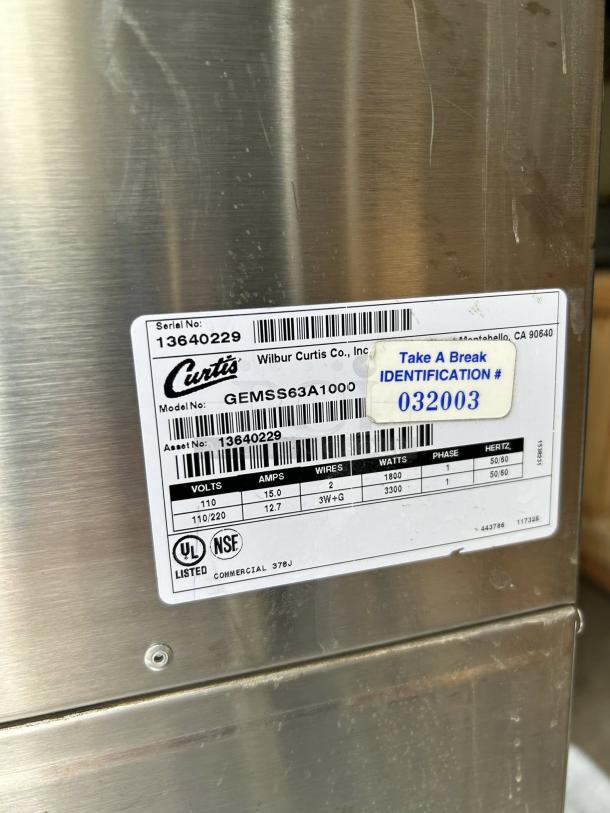 Curtis GEMSS63A1000 coffee brewer, stainless steel, 9-inch, 2.2-gallon tank, excellent condition, model tag visible.