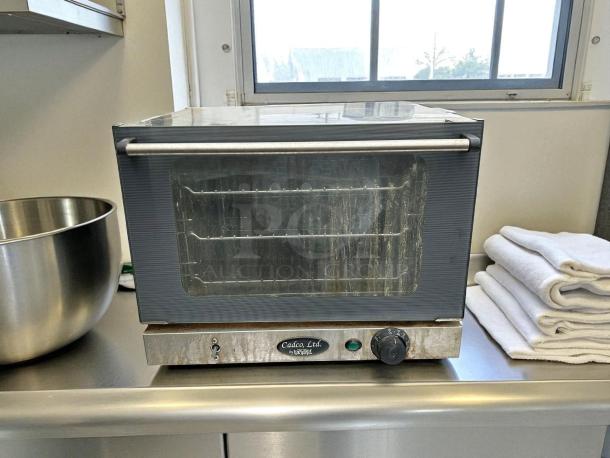 Cadco XA006 commercial convection oven in excellent condition on a countertop; visible dials and Cadco Ltd. label.