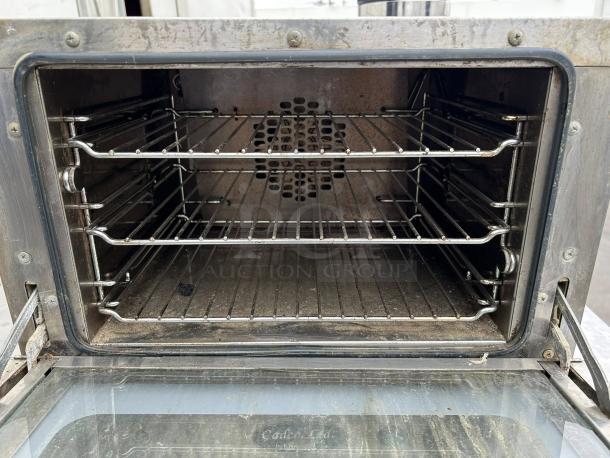 Cadco XA006 commercial convection oven, excellent condition, interior view with three racks visible, tested and working.