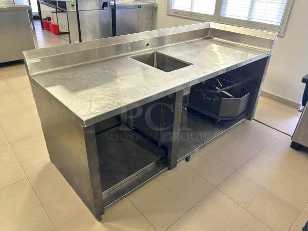 Winholt stainless steel sink and work table with 18"x12" basin, excellent condition, featuring sturdy construction.