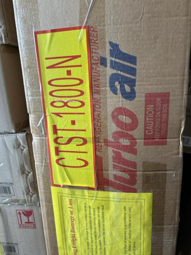 Brand new Turbo Air CTST-1800-N 72" E-Line refrigerated prep rail in packaging. Features a hinged lid; model and brand labeled.