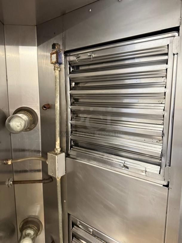 Giles 72" restaurant hood with exhaust system, stainless steel, tested and working, visible ductwork and louvers in good condition.