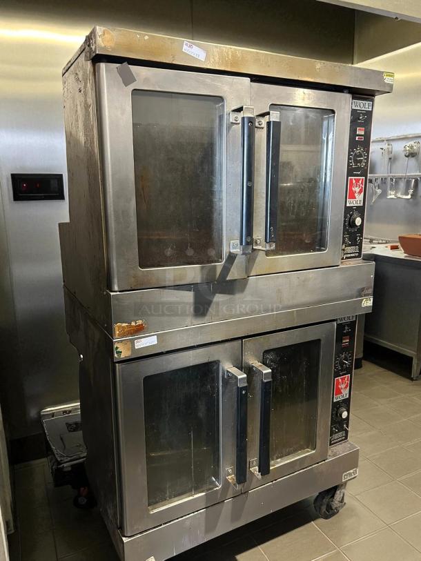 Wolf commercial gas double-deck convection oven, tested working, standard depth, stainless steel, visible wear, model details on panel.