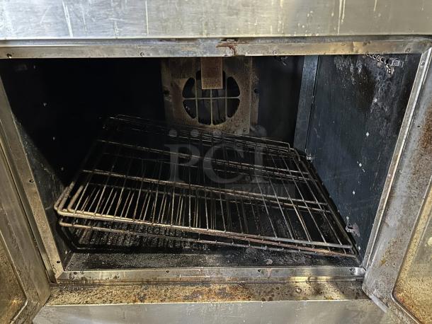 Wolf commercial gas double-deck convection oven, tested and working, features standard depth, visible racks, and interior wear.