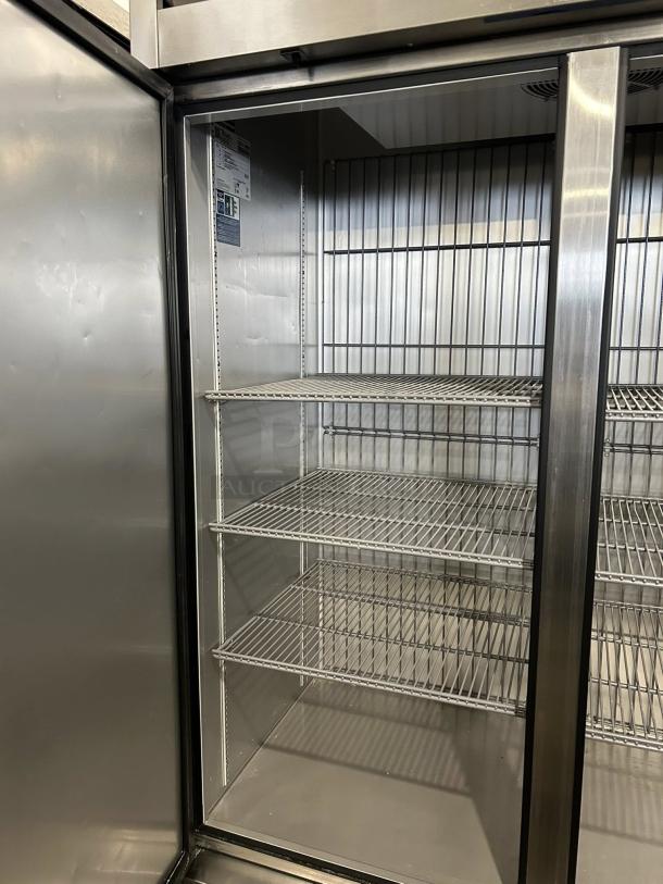 True T-49F-HC 49 Cu.Ft stainless reach-in freezer, excellent condition, tested and working, with shelves and visible label.
