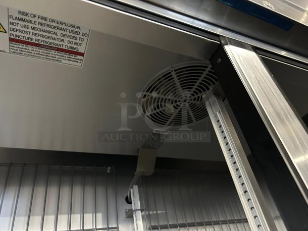 True T-49F-HC freezer interior view, showing fan, shelving, and caution label. Stainless steel, excellent condition.