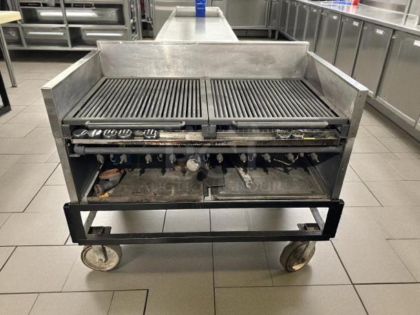 Heavy-duty 10-burner gas grill, tested and working. Features dual grates, sturdy metal construction, and large wheels for mobility.