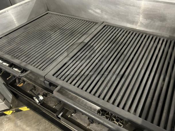 Heavy duty gas grill with 10 burners, stainless steel, tested and working, shows some wear, ideal for professional use.