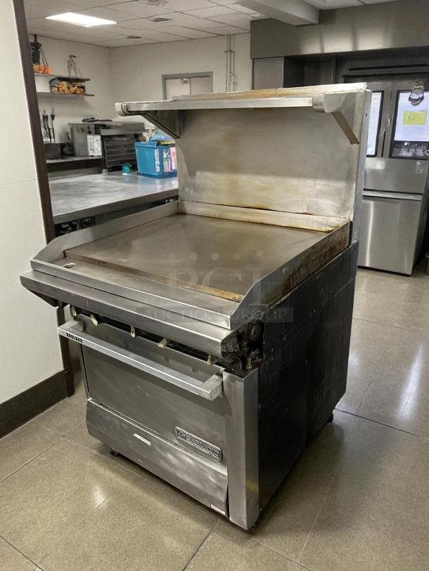 Garland M48R 34" gas range with full griddle, standard oven, stainless steel, excellent condition, tested and working.