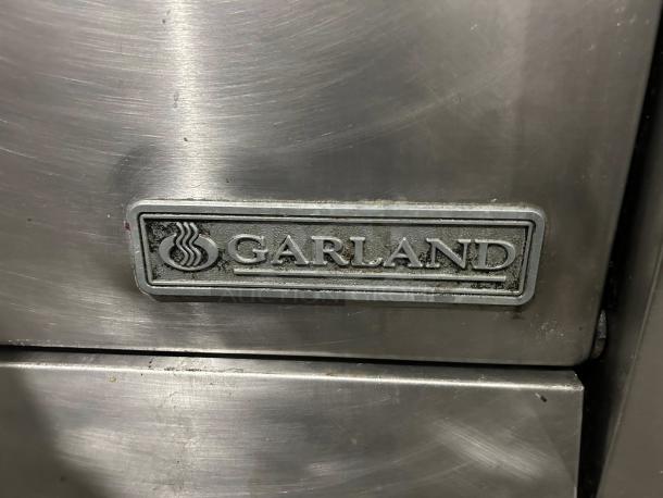 Garland M48R 34" gas range detail showing logo, stainless steel finish, excellent condition, tested and working.