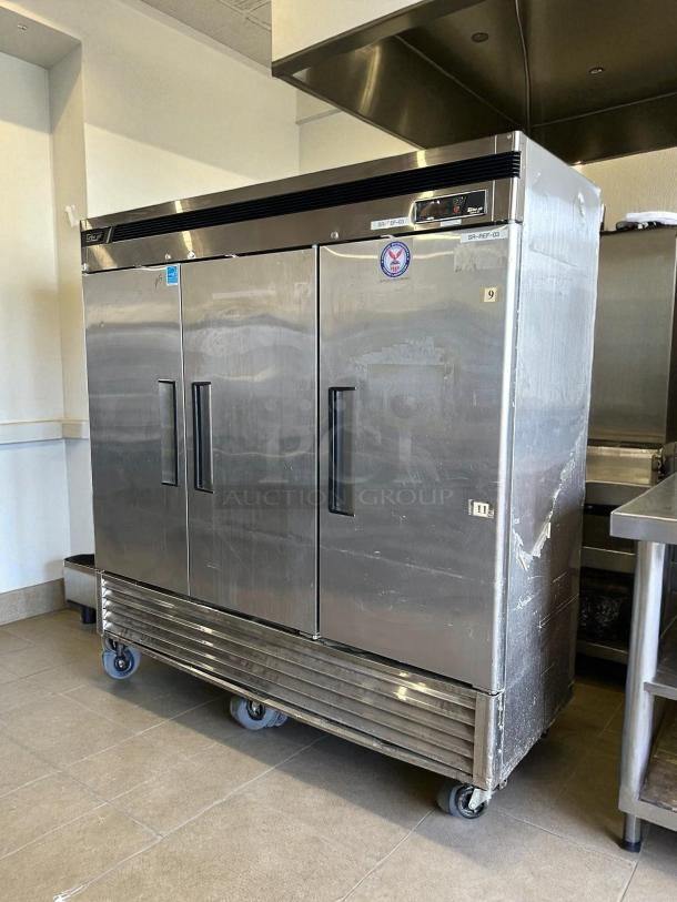 Turbo Air TSR-72SD-N reach-in refrigerator, 82", bottom-mounted, stainless steel, excellent condition, 3 solid doors, on casters.