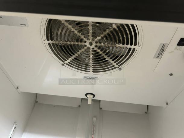Interior top view of a True GDM-23-HC cooler, showing fan and white interior. In great condition, 23 cu.ft capacity.