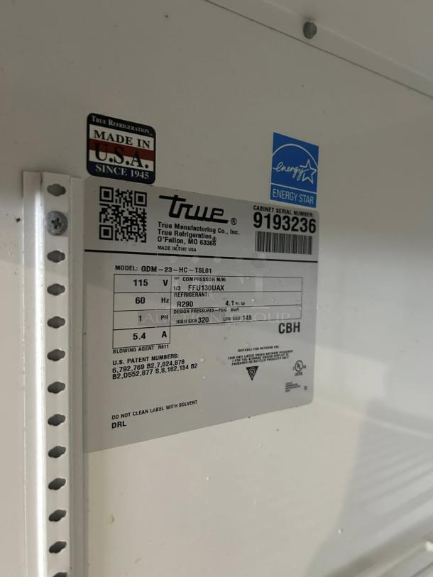 True GDM-23-HC~TSL01 cooler label, showing energy star certification and manufacturing details, model specifics visible.