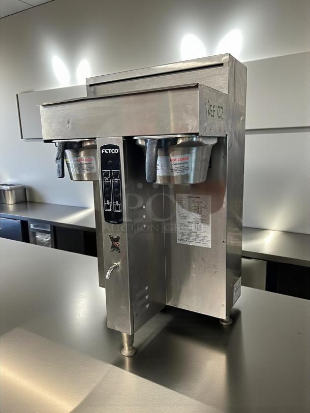 Fetco CBS-2052e dual station coffee brewer in excellent condition, 208-240V, fully tested, stainless steel, visible labels.