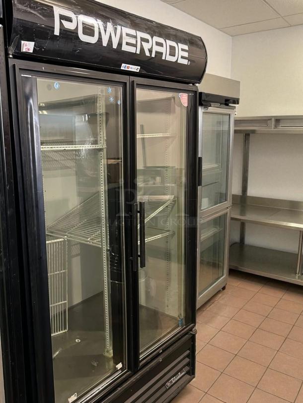 True GDM-43-HC glass door merchandiser, black, 47 1/8", two-section, tested, working, Powerade branding, shelving included.